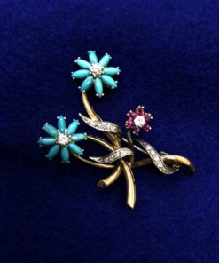 Broche con brillantes y flores de rubí y turquesas montado en oro bicolor  de ley 18kts