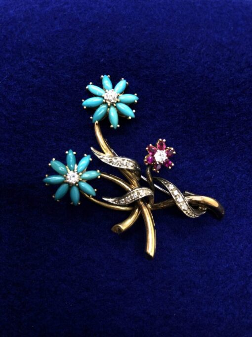 Broche con brillantes y flores de rubí y turquesas montado en oro bicolor  de ley 18kts