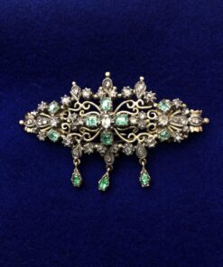 Broche con  diamantes y esmeraldas montado en oro amarillo de ley 18kts