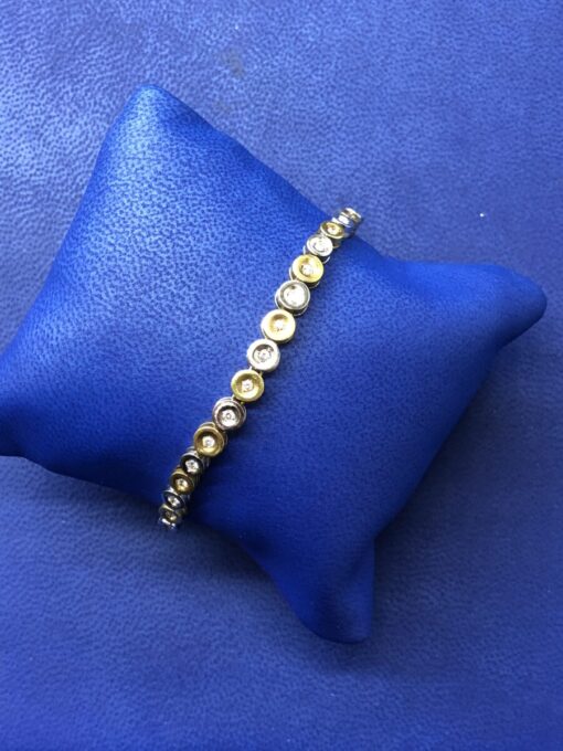 Pulsera con círculos con brillantes 1cts montado en oro bicolor de ley 18kts