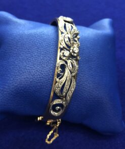 Pulsera media caña años 60 con diamantes montada en dos colores de oro 18 kts.