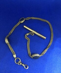 Leontina para reloj de bolsillo con piedra lapislázuli montada en oro amarillo de ley 18 kts.