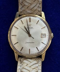 RELOJ OMEGA AUTOMÁTICO. EN ORO AMARILLO D LEY 18KTS Y PULSERA TRENZADA BEIGE.