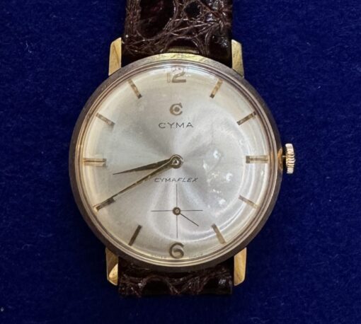 RELOJ CYMA FLEX DE CUERDA. CON SEGUNDERO A LAS 6. EN ORO 18KTS Y PULSERA DE PIEL.
