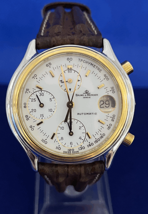 Reloj Baume & Mercier, acero y oro amarillo de ley 18 kts., automático, con pulsera de piel