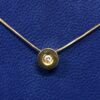 Colgante de brillante 0,12 cts, montado en chatón de oro amarillo de ley 18 kts