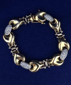 Pulsera bicolor con eslabones tipo corazón y eslabones con circonitas en oro de ley 18 kts
