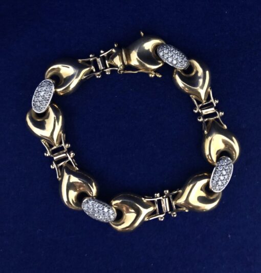 Pulsera bicolor con eslabones tipo corazón y eslabones con circonitas en oro de ley 18 kts