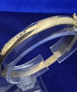 Pulsera media caña labrada montada en oro de ley 18 kts.