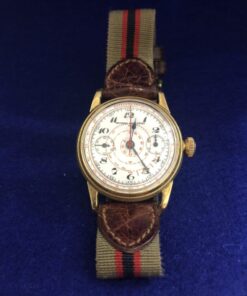 Reloj de caballero Universal Watch 33mm, en oro de ley 18 kts, mecanismo de cuerda con pulsera de tela