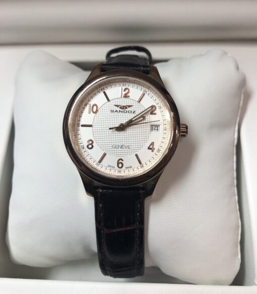 Reloj Sandoz Modelo 81312-0058, 31mm, calendario y  agujas luminiscentes, mecanismo de cuarzo. Maquinaria suiza y cristal de zafiro. De acero con baño de oro rosa.