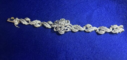 Pulsera vintage (años 60), vistas en oro blanco con roleos y motivo floral al centro, enriquecida con 1'80 cts de diamantes, en oro de ley 18 kts. - Imagen 2