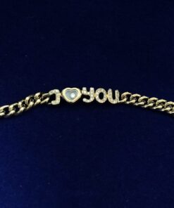 Pulsera Chopard modelo "I love you" Happy Diamonds, en oro de ley 18 kts, con contrastes originales de la marca.