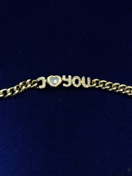 Pulsera Chopard modelo "I love you" Happy Diamonds, en oro de ley 18 kts, con contrastes originales de la marca.