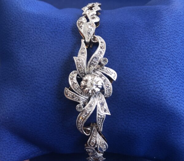 Pulsera vintage (años 60) de roleos, con vistas en platino y diamantes, en oro amarillo de ley 18 kts.