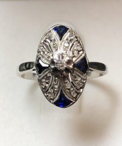 Sortija lanzadera Art Decó con zafiros reconstituidos y 0'25 cts de diamantes en oro blanco de ley 18 kts.