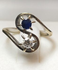 Sortija "tú y yo" con zafiro de 0'15 cts y brillante de 0'17 cts en oro blanco de ley 18 kts.