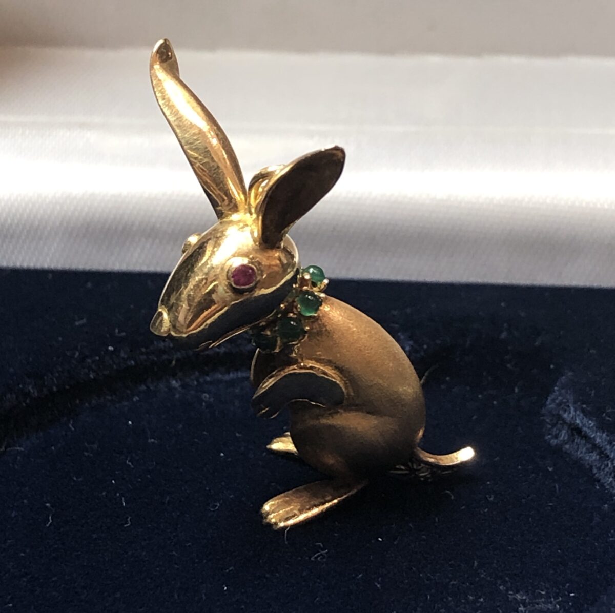 Colgante en forma de canguro, con detalles en rubí, esmeraldas y brillantitos, en oro amarillo de ley 18 kts.