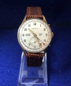 Reloj vintage Movado, con cronógrafo y calendario perpetuo, de 34 mm, en oro de ley 18 kts. con pulsera marrón de piel. Mecanismo de cuerda