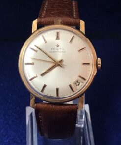 Reloj Zenith vintage de caballero, con fecha a las V, esfera de 34 mm, en oro de ley 18 kts. con pulsera marrón de piel genuina. Automático