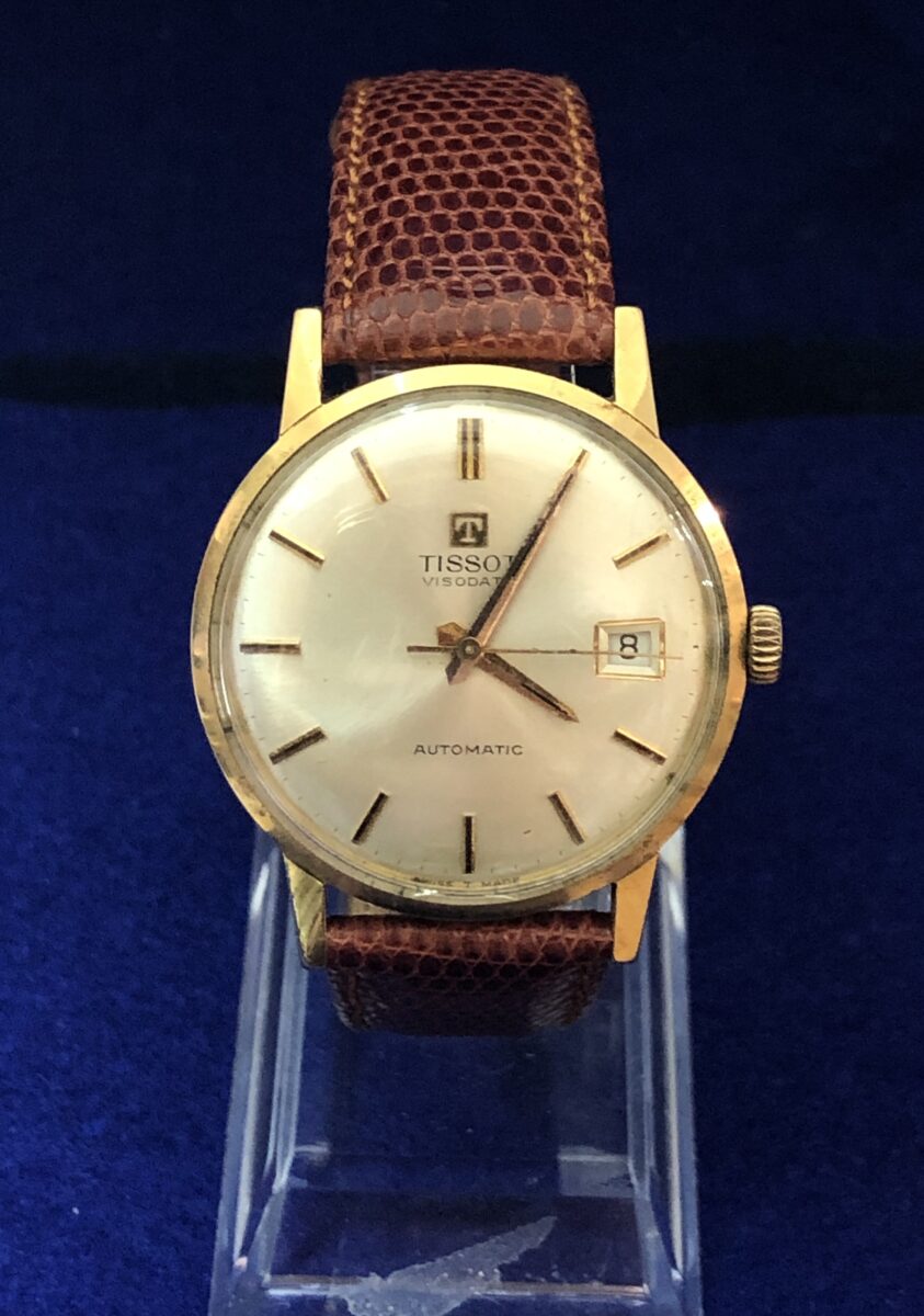 Reloj TISSOT VISODATE vintage de caballero, esfera de 34mm, en oro de ley 18 kts. con pulsera marrón de piel genuina. AUTOMÁTICO