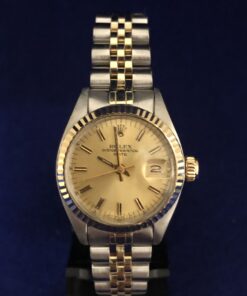 Rolex Lady Date 28mm, Modelo 6917, con esfera dorada y cristal de plexiglas, pulsera jubilee de acero y oro amarillo 18 kts, automático, año 1980