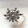 Sortija en forma de rosetón con brillante central de 2'30 cts en oro blanco de ley 18 kts.