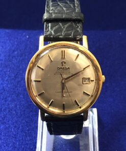 Reloj Omega Constellation vintage de esfera dorada, automático con fecha, con correa y hebilla originales de la marca, realizado en oro amarillo de ley 18 kts.