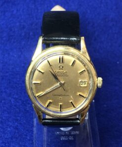 Reloj Omega Constellation vintage de esfera dorada con fecha, realizado en oro de ley 18 kts, automático con cronómetro y correa negra de piel genuina