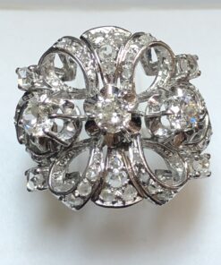 Espectacular sortija vintage estilo Hollywood (años 60), en forma de lazo con 3 brillantes centrales, y 1'10 cts de brillantes en total, realizada en oro blanco de ley 18 kts.